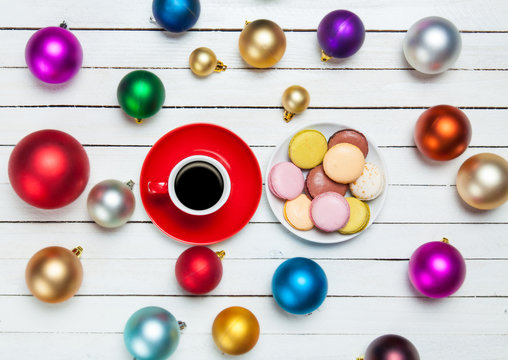 Cup of coffee and cookie with christmas toys on whte background.
