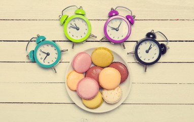 Clock and macaron with christmas toys.