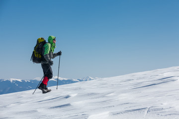 Fototapeta na wymiar Hiker in winter mountains on sunny day