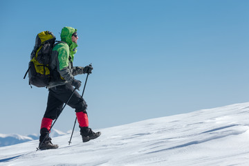 Fototapeta premium Hiker in winter mountains on sunny day