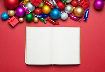 Book and chritmas toys on white background.