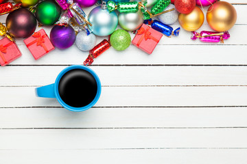 Coffee cup and christmas toys on white background.