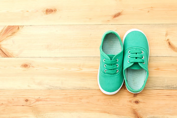 Green  shoes on wooden floor.