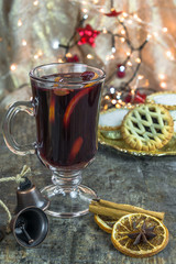 Mulled wine, mince pies and spices on wooden background © beataaldridge