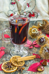 Mulled wine and spices on wooden background
