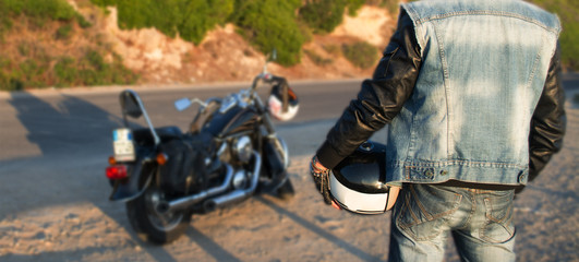 biker and motorcycle on the edge of the road