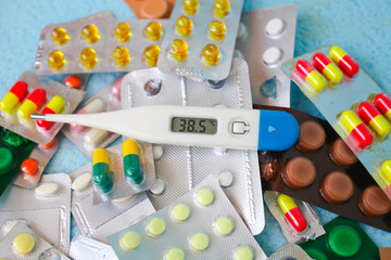 The medical thermometer and medicines in tablets