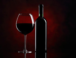 Red wine glass with bottle