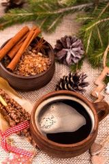 Mug of coffee with cinnamon and chocolate sticks