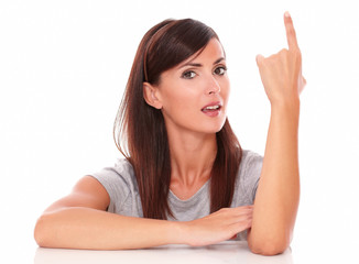 Attractive lady pointing up and looking at you