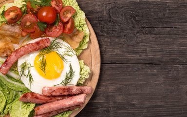Rustic fried egg with ham and tomatoes top view