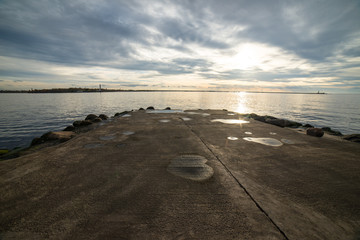 breakwater in the sea with lighthouse on it