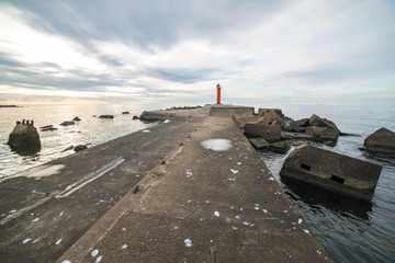 breakwater in the sea with lighthouse on it