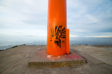 breakwater in the sea with lighthouse on it