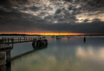 Fototapeta na wymiar Sunset over Poole Harbour at Hamworthy pier
