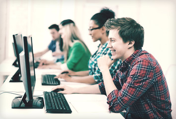 student with computer studying at school