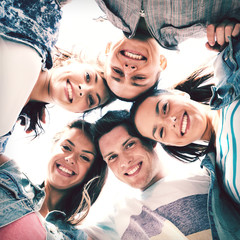 group of teenagers looking down