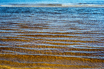 icy sea beach with first ice pieces