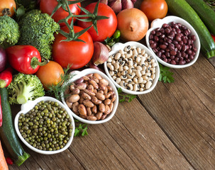 Legumes in bowls and vegetables
