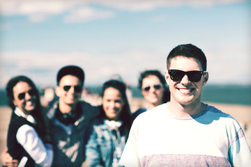 teenager in shades outside with friends