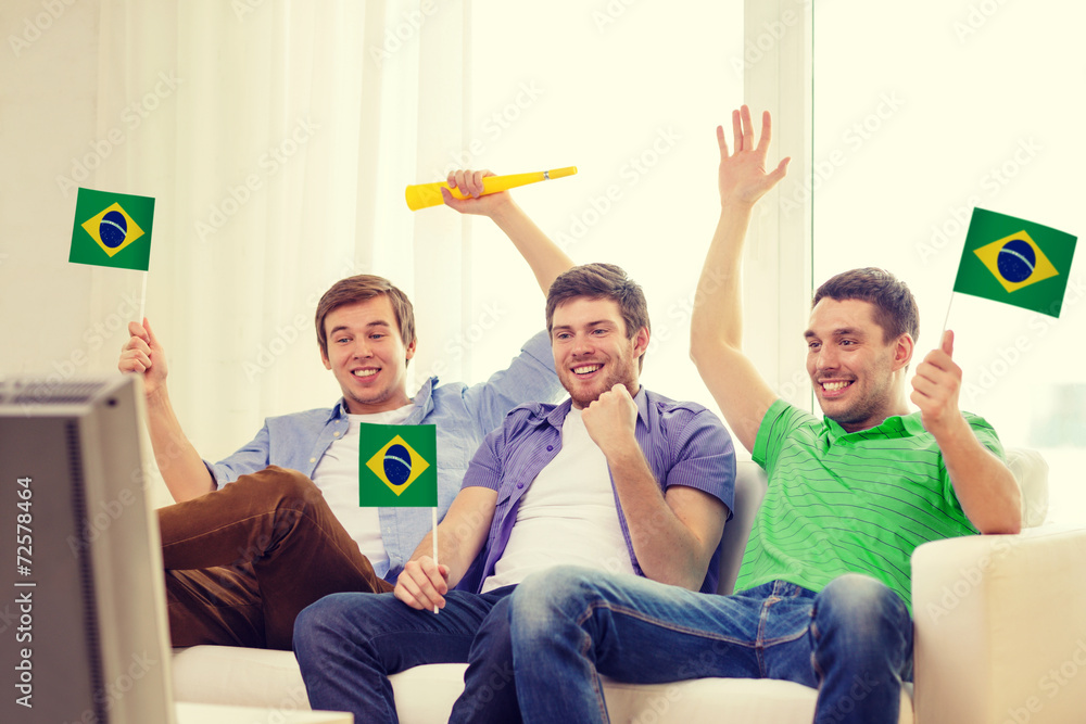 Wall mural happy male friends with flags and vuvuzela