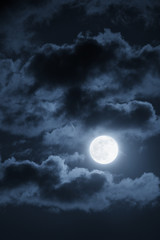 Fototapeta na wymiar Dramatic Nighttime Clouds and Sky With Beautiful Full Blue Moon