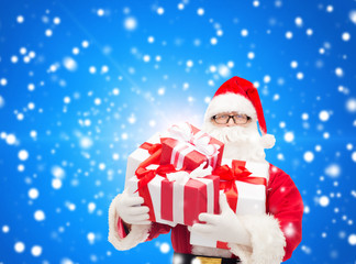 man in costume of santa claus with gift boxes
