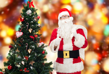 santa claus with bag and christmas tree