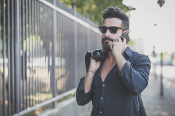 young handsome attractive bearded model man using smartphone