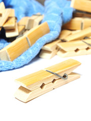 Wooden clothes pin and laundered denim fabric isolated on white