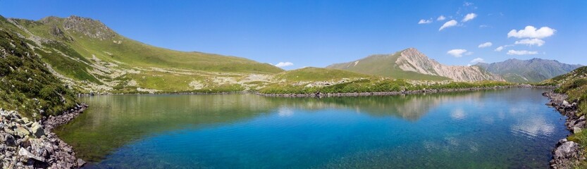 Fototapeta na wymiar Panorama mountain lake in alps
