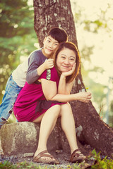 Naklejka premium Son hugging mother Asian family