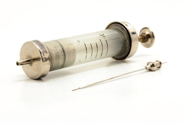 Vintage syringe needle in container on white background