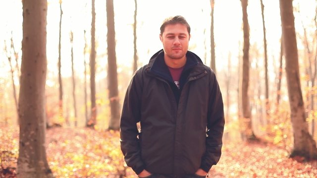 Male looking at the camera in a forest