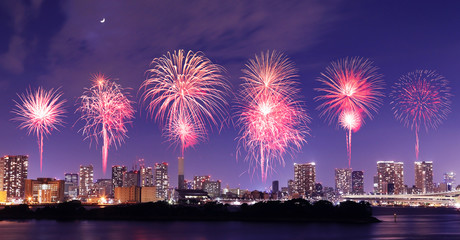 Fireworks celebrating over Tokyo cityscape at nigh
