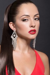 Fototapeta premium Fashion Woman Portrait in evening dress and with jewelery