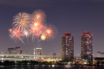 Fireworks celebrating over Tokyo cityscape at nigh