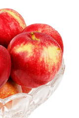 Red apples in a glass vase