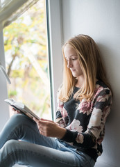 young beautiful girl reading a book