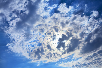 Blue sky with clouds covering the sun. Can be used as background