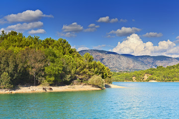 View of the coast and the mountains from the water side.