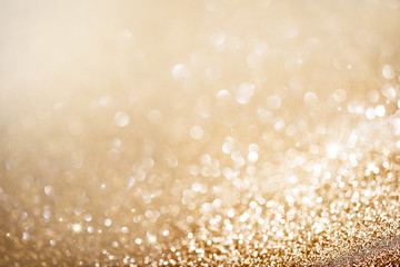 Christmas gold background. Golden holiday glowing background