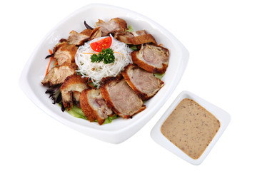 Slices roasted beijing duck  in a plate isolated on white.