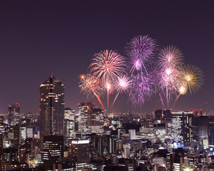 Fireworks celebrating over Tokyo cityscape at night