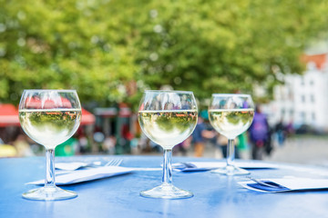 Three glasses of white wine outdoors