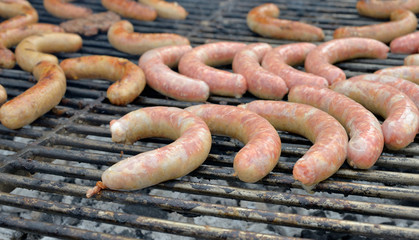 Fototapeta premium Cooking of big sausages outdoors