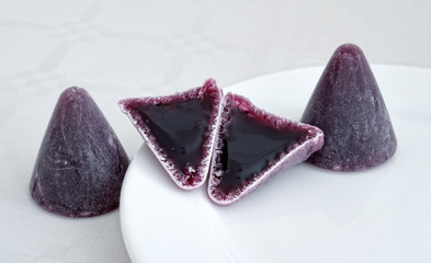 Purple traditional Belgian candies cuberdons