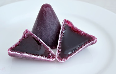 Purple traditional Belgian candies cuberdons - 72594429