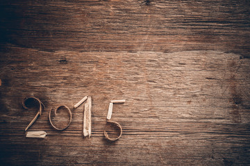 Happy New Year 2015 greetings on vintage wooden background