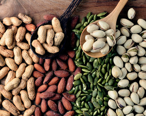 Nuts and dried fruits on vintage wooden boards still life